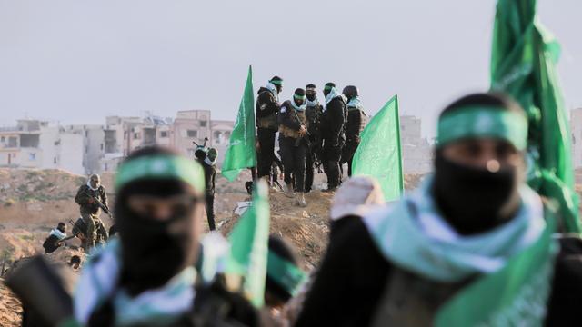 Palästinensische Hamas-Kämpfer versammeln sich am 20. Februar 2025 am Ort der Übergabe der Leichen von vier israelischen Geiseln in Khan Yunis im südlichen Gazastreifen. 